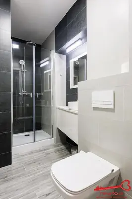 a white bathroom with a shower and a toilet at Apartment Old Town Topolowa in Kraków
