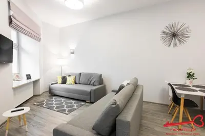 a living room with a couch and a table at Apartment Old Town Topolowa in Kraków