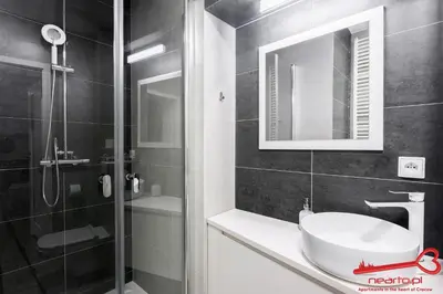 a bathroom with a sink and a shower at Apartment Old Town Topolowa in Kraków