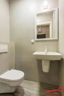 a bathroom with a toilet and a sink and a mirror at Apartment Old Town Topolowa in Kraków