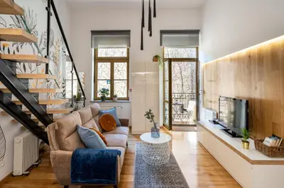 a living room with a couch and a tv at Home Sweet Home in Kraków