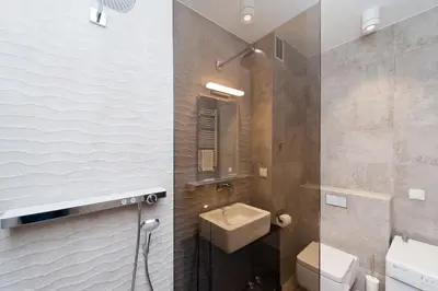 a bathroom with a sink and a toilet at Kazimierz Luxory, Sun & Snow in Kraków