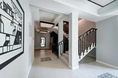 a hallway of a home with white walls and stairs at Kazimierz Luxory, Sun & Snow in Kraków