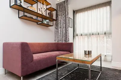 a living room with a purple couch and a table at Kazimierz Luxory, Sun & Snow in Kraków