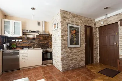 a kitchen with a brick wall and a stove at Angel's studio - Jewish Quarter, Old Town (AirCon) in Kraków