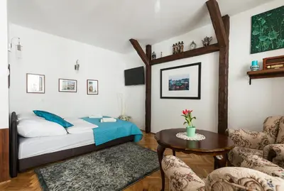 a bedroom with a bed and a table and chairs at Angel's studio - Jewish Quarter, Old Town (AirCon) in Kraków