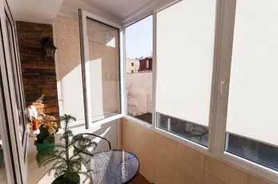 a balcony with two windows and a table and chair at Angel's studio - Jewish Quarter, Old Town (AirCon) in Kraków
