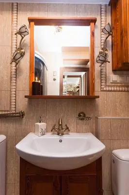 a bathroom with a sink and a mirror and a toilet at Angel's studio - Jewish Quarter, Old Town (AirCon) in Kraków