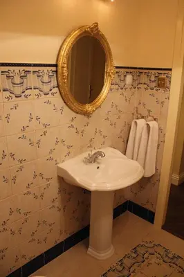 a bathroom with a sink and a mirror at Cracow Apartments 24 in Kraków