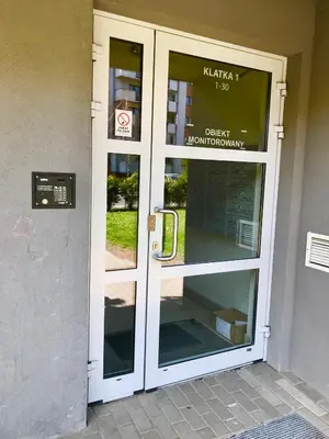 a front door of a building with a sign on it at Apartament 5 in Kraków