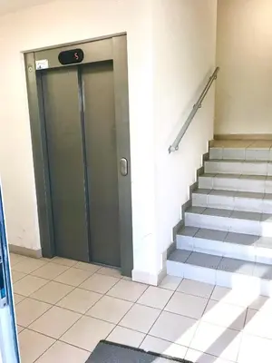 a revolving door in a building with stairs at Apartament 5 in Kraków