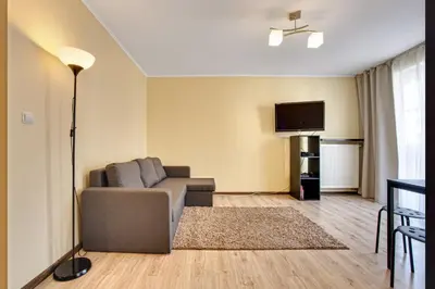 a living room with a couch and a flat screen tv at Apartament 5 in Kraków
