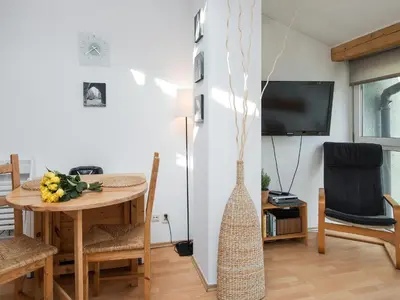 a dining room with a table and a tv at Studio Smart Apartment in Kraków