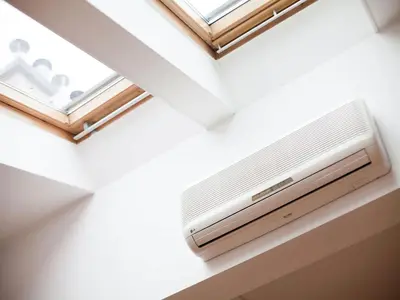 a air conditioner in a room with a window at Studio Smart Apartment in Kraków