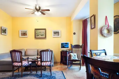 a living room with a couch and chairs at Trinity Apartment in Kraków