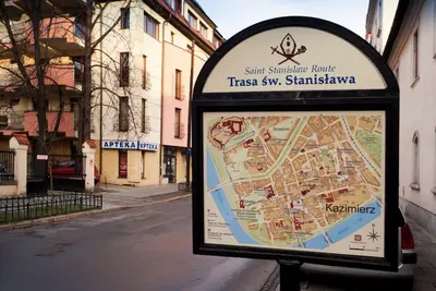 a sign on the side of a street at Trinity Apartment in Kraków