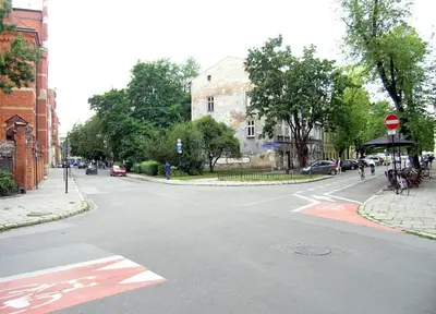 an empty street with a stop sign on the road at Trinity Apartment in Kraków