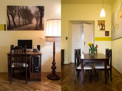 a room with a desk and a table with a lamp at Old Town Apartment in Kraków