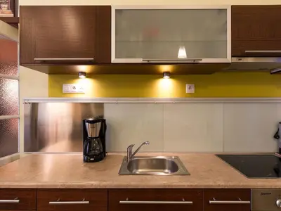 a kitchen with a sink and a counter top at Old Town Apartment in Kraków