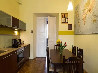 a kitchen with a table and a dining room at Old Town Apartment in Kraków