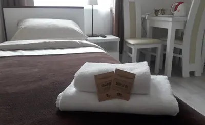 a box sitting on top of towels on a bed at Cracow Central Aparthotel in Kraków