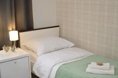 a bedroom with a bed with towels on it at Cracow Central Aparthotel in Kraków