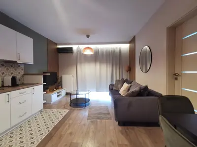 a living room with a couch and a table at White Swan Apartment in Kraków