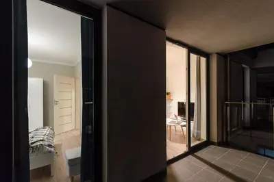 a room with a door leading to a bedroom at White Swan Apartment in Kraków