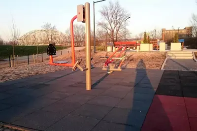 an empty playground with orange equipment at a park at White Swan Apartment in Kraków