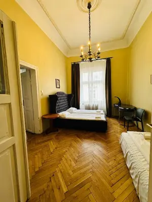 a bedroom with a bed and a window with a chandelier at Main Market Square Apartments in Kraków