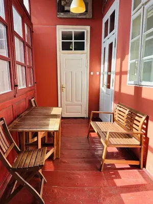 a room with two wooden benches and a door at Main Market Square Apartments in Kraków
