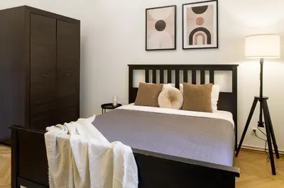 a bedroom with a large bed with pillows at WAWELOVE spacious 3 bedroom apt 1 min to Main Sq! in Kraków