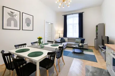 a living room with a table and a couch at WAWELOVE spacious 3 bedroom apt 1 min to Main Sq! in Kraków