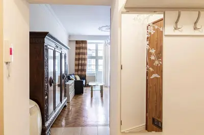 a room with a hallway with a living room at Floriańska Glamour Apartments in Kraków