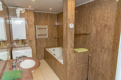 a bathroom with a sink and a shower at P&J Apartamenty Grodzka in Kraków