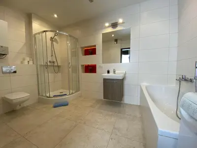 a bathroom with a shower and a toilet and a sink at P&J Apartamenty Grodzka in Kraków