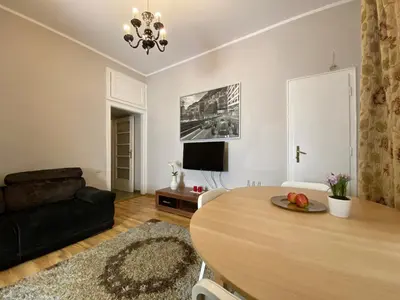 a living room with a table and a couch at P&J Apartamenty Św. Krzyża in Kraków