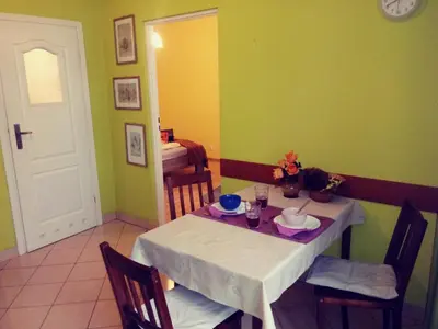 a dining room with a white table and chairs at AP Na Groblach in Kraków