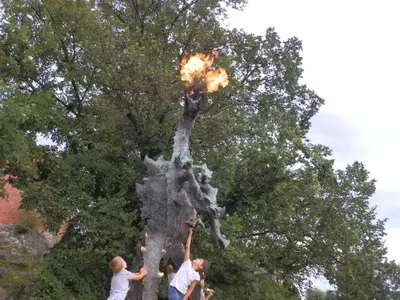 a group of people with fire in a tree at AP Na Groblach in Kraków