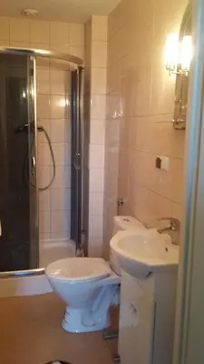 a bathroom with a toilet and a sink and a shower at AP Na Groblach in Kraków