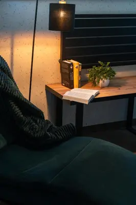 a desk with a telephone and a book on it at Apartament Blisko Słońca - Jacuzzi na wyłączność in Nowy Targ