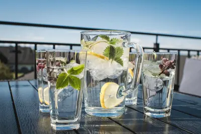 four glasses of water with ice and lemon on a table at Apartament Blisko Słońca - Jacuzzi na wyłączność in Nowy Targ