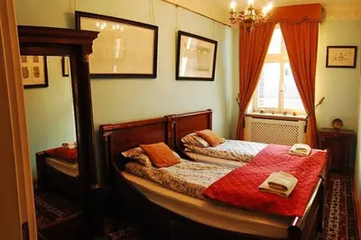 a bedroom with a bed with a red blanket at Royal in Kraków