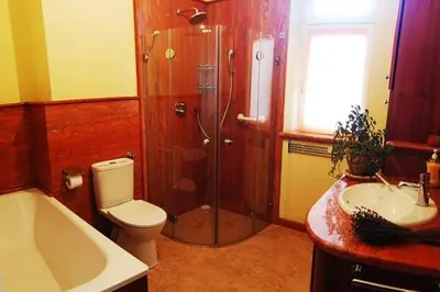 a bathroom with a shower and a toilet and a sink at Royal in Kraków
