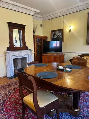 a living room with a wooden table and a fireplace at Royal in Kraków