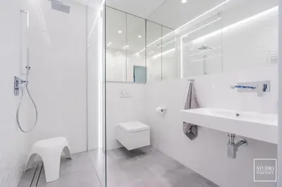 a white bathroom with a sink and a toilet at Apartamenty Premium Wadowice in Wadowice