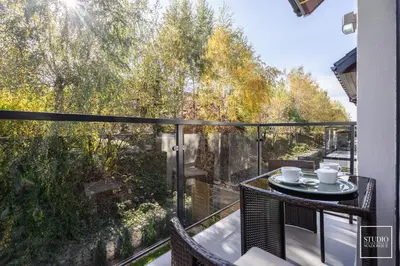 a balcony with a table with two coffee cups on it at Apartamenty Premium Wadowice in Wadowice