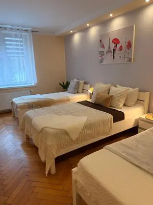 a room with three beds in a room at Apartament u Janka in Wieliczka