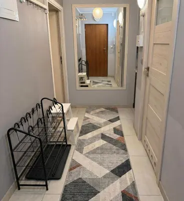 a bathroom with a sink and a washing machine at Apartament u Janka in Wieliczka