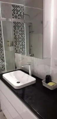 a kitchen with white cabinets and a sink at Apartament u Janka in Wieliczka